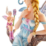 Elegant blonde fairy in a pale blue dress and glittery wings relaxing on a tree branch with a tiny pixie and hyacinth flowers.