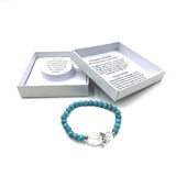 Turquoise crystal bracelet with heart charm and guardian angel, symbolizing love, strength, and positivity.