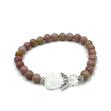 Rhodochrosite bead bracelet with heart guardian angel charm, promoting emotional healing and self-love in a beautiful design.