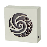 Koru Cream LED Block featuring a spiral Koru design, emanating warm light for a serene and inviting ambiance.