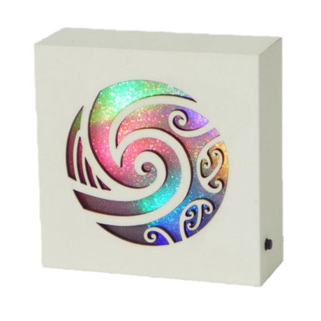 Koru Cream LED Block with spiral Maori design, softly glowing light for peaceful ambiance in home decor.