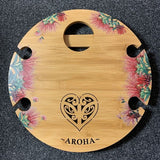 Eco-friendly Aroha Bamboo Round Table, perfect for holding wine and glasses outdoors; lightweight and portable design.