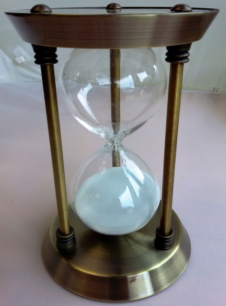 Elegant 30-minute hourglass with a sleek white stand, perfect for timers and home decor, standing at 25 cm tall.