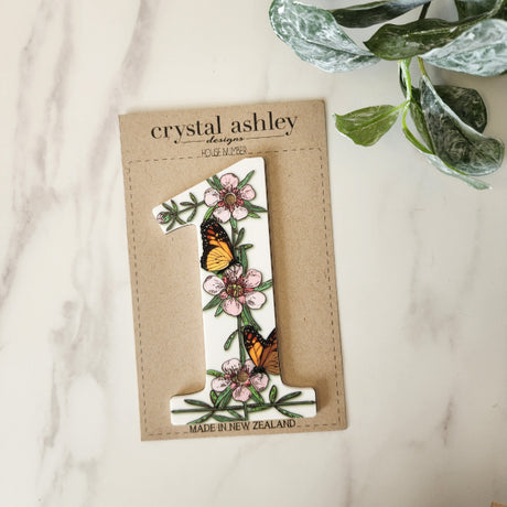 House number featuring NZ floral designs, crafted from durable white acrylic, 12cm tall, ideal for enhancing curb appeal.