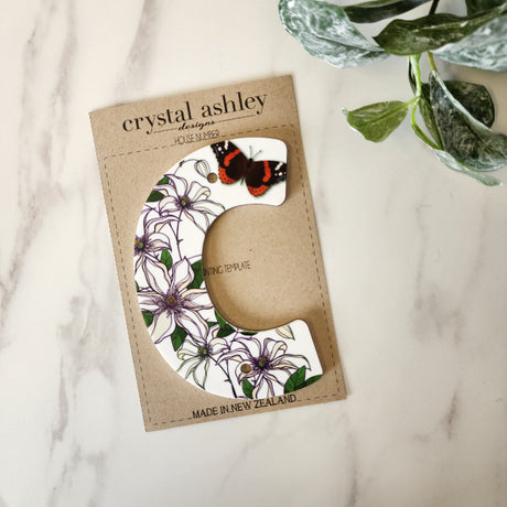White acrylic house number "C" with NZ floral design, 12cm tall, ideal for modern or classic homes, includes mounting template.