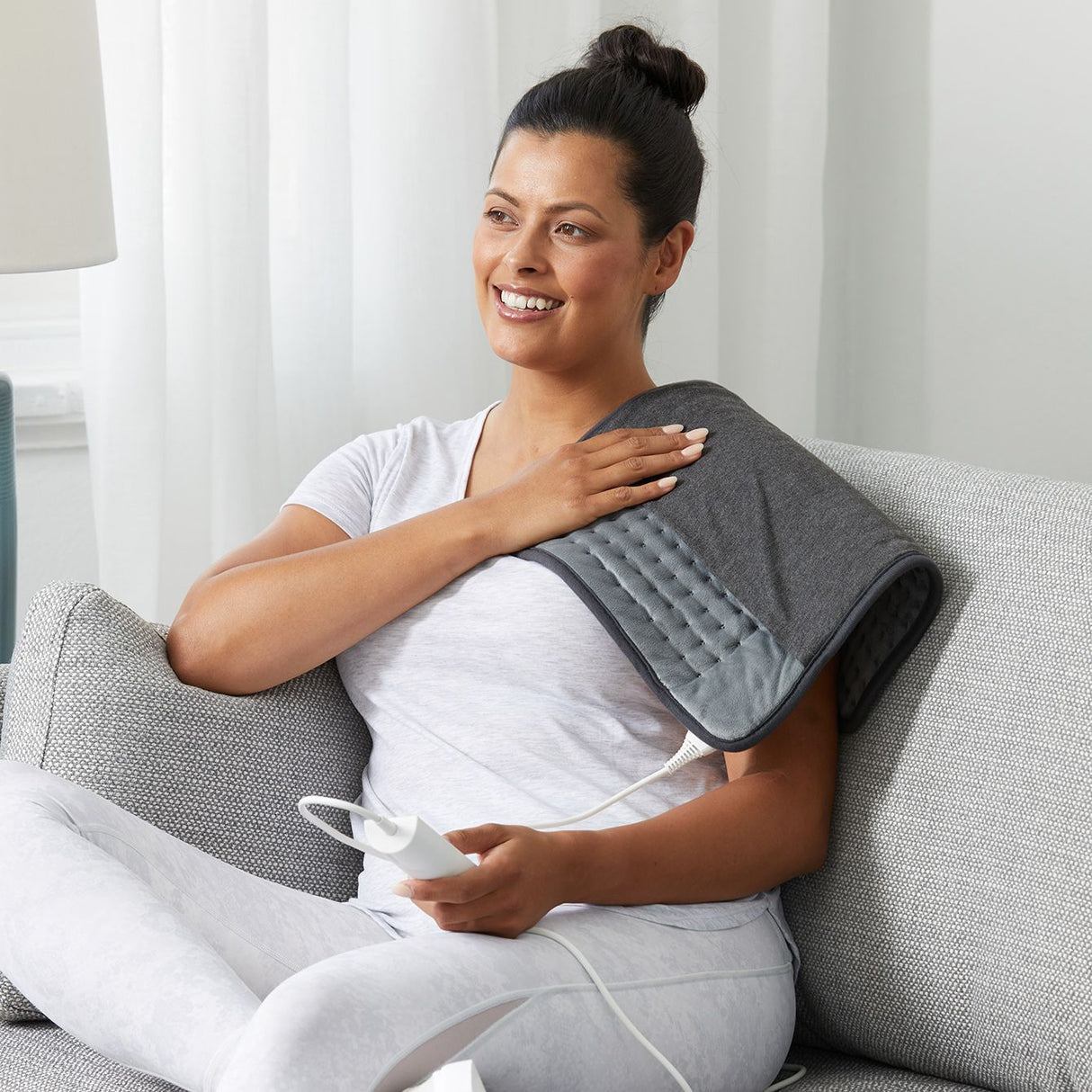 Multipurpose heating pad by Sunbeam, offering adjustable heat, rapid warming, and safety features for muscle relaxation.