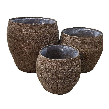 Handcrafted set of 3 curved seagrass planters, eco-friendly, with plastic lining for indoor gardening, showcasing natural elegance.