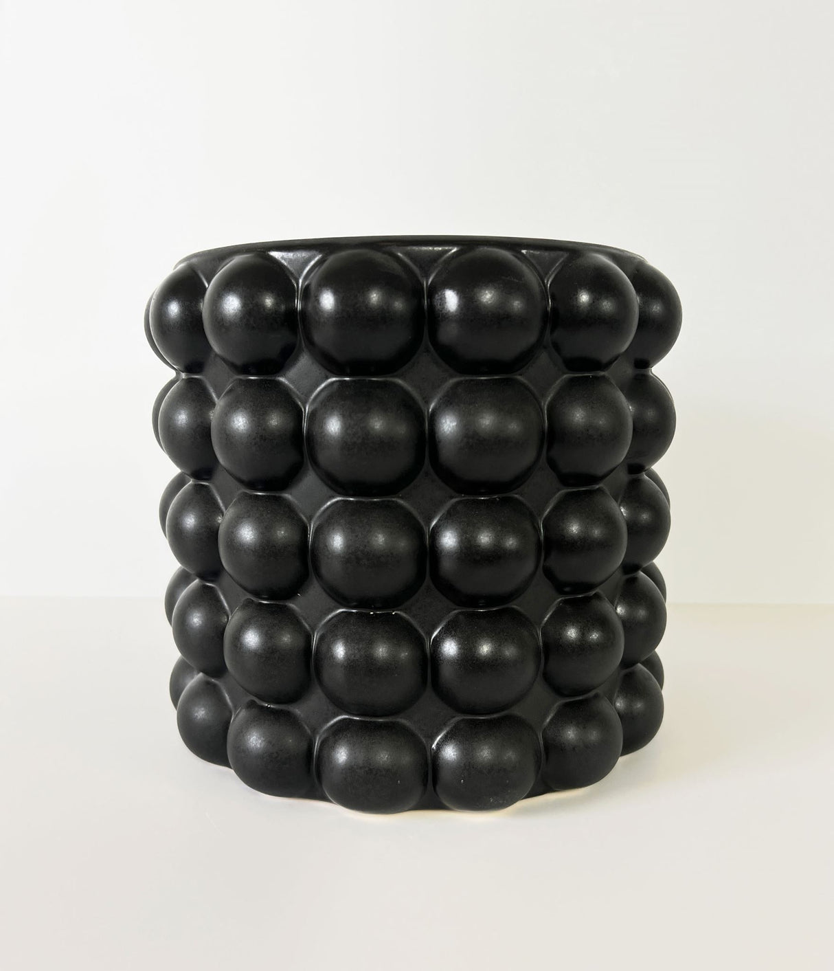 Sleek black BOBBLE Small Planter, handcrafted with a unique matte-gloss finish, perfect for modern plant displays.