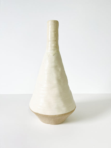 Tall cream bud vase, handcrafted with a glazed finish, perfect for elegant home decor and floral arrangements.