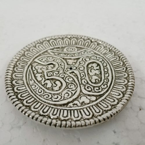 White metal round incense holder featuring the OM symbol, 9cm size, perfect for meditation and home decor.