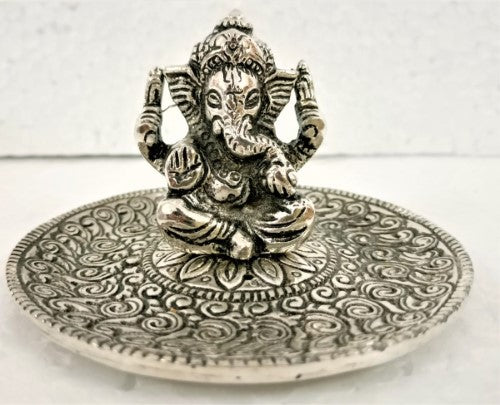 White metal round incense holder featuring intricate Ganesha designs, perfect for meditation and enhancing spiritual spaces.