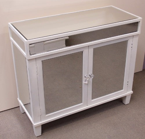 Elegant mirrored cabinet with beveled mirrors and crystal knobs, perfect for stylish storage in any room.
