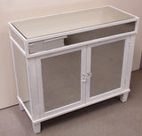 Elegant mirrored cabinet with beveled mirrors and crystal knobs, perfect for stylish storage in any room.