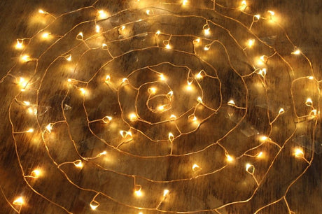 Delicate copper wire LED fairy lights with 100 bulbs, creating a warm, magical atmosphere for any occasion.
