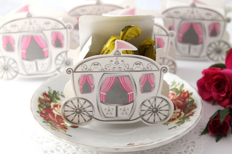 Ten Cinderella carriage favour boxes, intricately designed, sturdy cardboard, ideal for weddings and themed events.