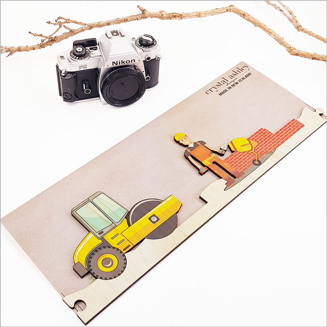 Pine jigsaw puzzle wall art featuring a construction site theme, crafted from eco-friendly pine veneer for playful decor.