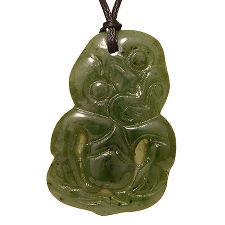 Exquisite jade Tiki pendant, 42mm x 28mm, featuring unique carvings symbolizing good luck and fertility on an adjustable cord.