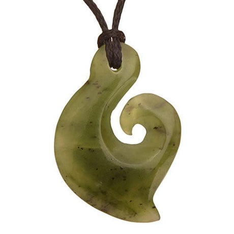 Small hand-carved Nephrite Jade Hook pendant on a black wax cord, symbolizing good fortune and Maori cultural heritage.