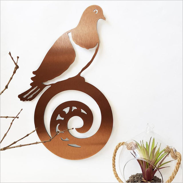 Kiwiana wall art featuring a kereru on koru design in brushed copper, ideal for enhancing indoor or outdoor spaces.