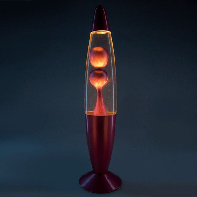 Pink metallic motion lamp in rocket shape with flowing lava, creating a soothing ambiance and retro charm for any room.