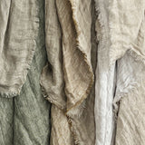 Elegant reversible linen throw, 125 x 150 cm, featuring a two-tone design and distressed eyelash edge for cozy home decor.