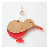 Vibrant red Kiwi Ornament made from bamboo and satin acrylic, perfect for holiday decor or as a thoughtful gift.