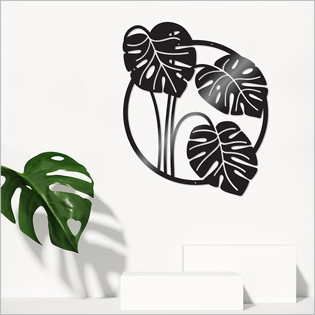 Large white circle wall art featuring a monstera deliciosa leaf, perfect for indoor and outdoor decor.