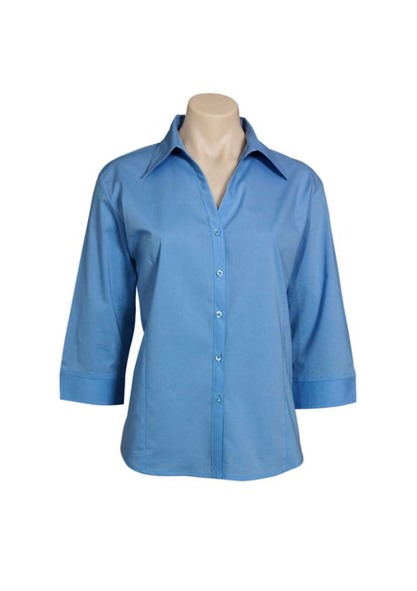 Mid blue 3/4 sleeve women's shirt in size 22, featuring an open neckline, cuffed sleeves, and curved hem for versatile styling.