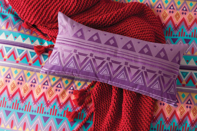 Long Akeem Purple cushion featuring vibrant Navajo-inspired design, ideal for adding style to sofas or beds.