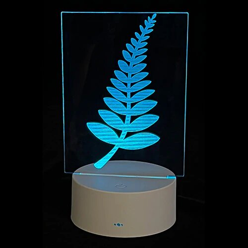 NZ Fern Logo LED Effect Light in color box, showcasing vibrant colors for a cozy atmosphere, ideal for children's rooms or decor.