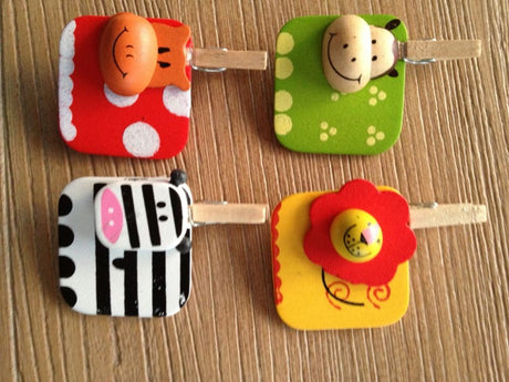Colorful 4-pack wooden animal pegs, perfect for crafts, card making, and playful decorations, measuring 3cm square each.