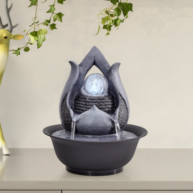 Elegant flower-shaped water feature with rolling ball, multi-colored lights, perfect for indoor or outdoor ambiance.