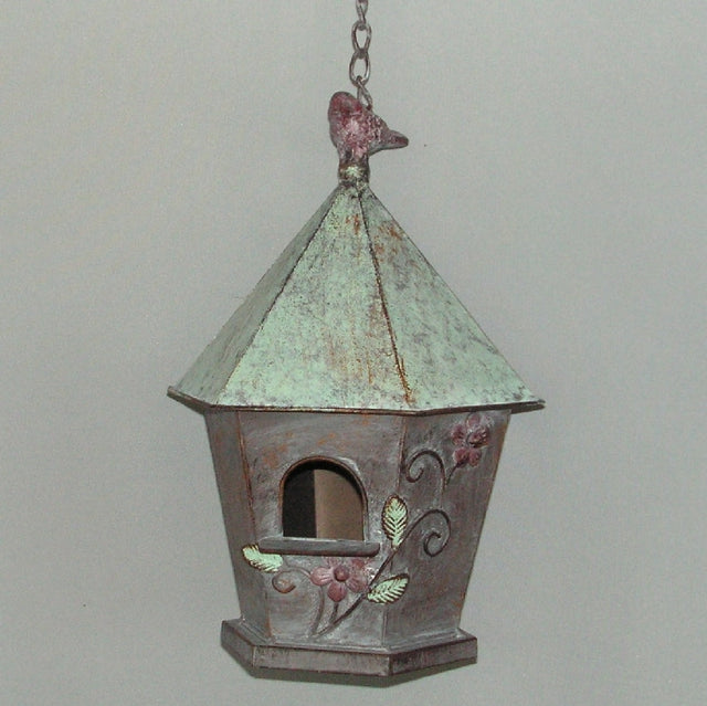 Cylindrical brown birdhouse, 58cm tall, designed for nesting birds, enhances garden decor and attracts various bird species.