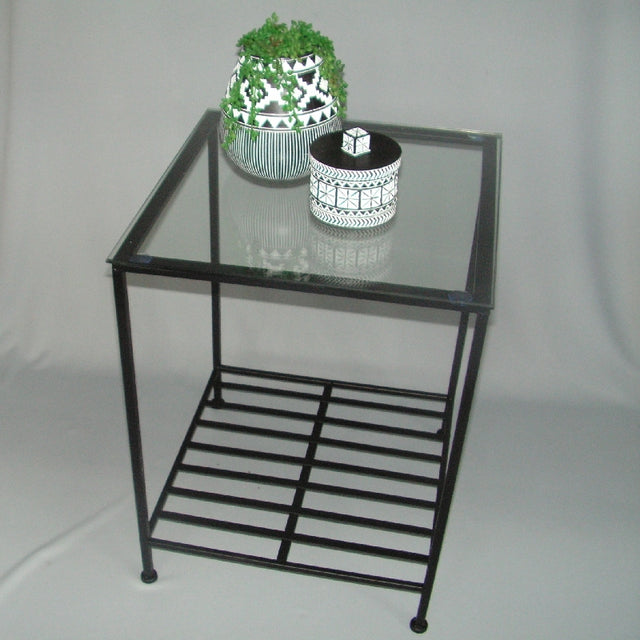 Modern 60cm side table with glass top and sturdy shelf, perfect for stylish storage in any room.