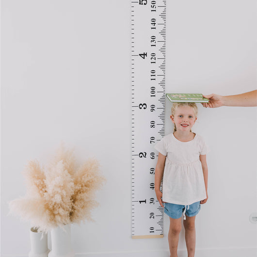 Moose Measure Me Height Chart in canvas and wood, designed to track children's growth with a whimsical ruler motif.