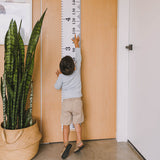 Moose Measure Me Height Chart for kids, crafted from durable canvas and wood, stylishly tracks growth milestones.