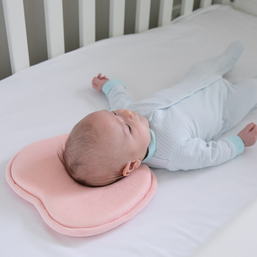 Pink Moose Baby Head Shape Support pillow made of memory foam, designed to cradle baby’s head and prevent Flat Head Syndrome.