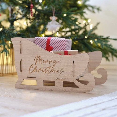 Whimsical handcrafted wooden sleigh for Christmas decor, featuring side panels and a sturdy base, eco-friendly and charming.