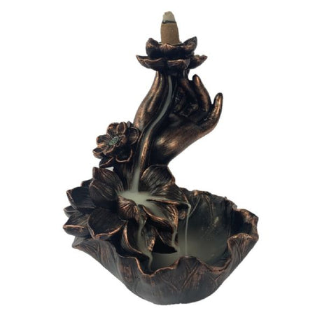 Intricate bronze backflow burner with lotus and hand design, creating a mesmerizing smoke waterfall effect for relaxation.