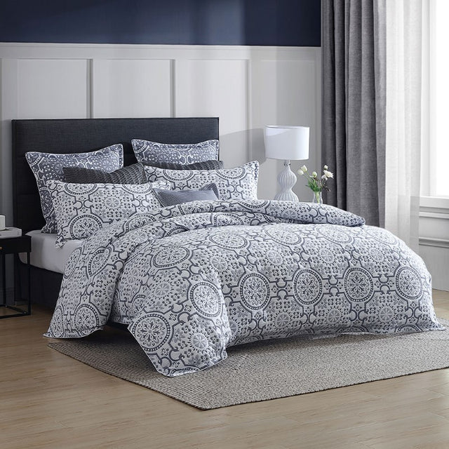 Luxurious Mayfair Navy Super King duvet cover set with intricate blue motifs on a white backdrop, offering style and comfort.