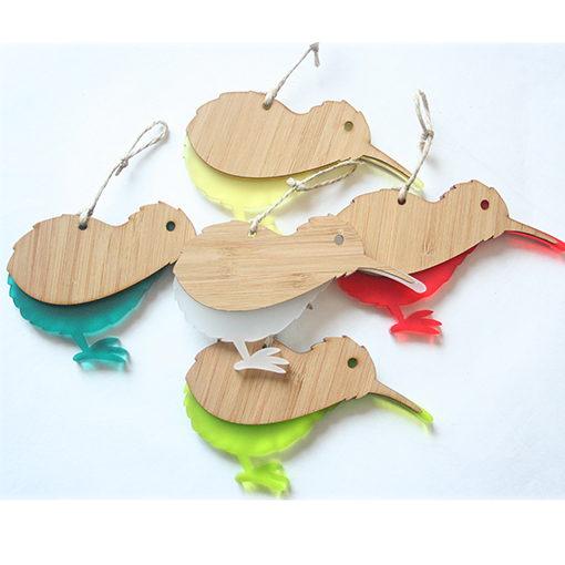 Eco-friendly Kiwi Ornament in white satin acrylic and bamboo, perfect for holiday decor and gifting.