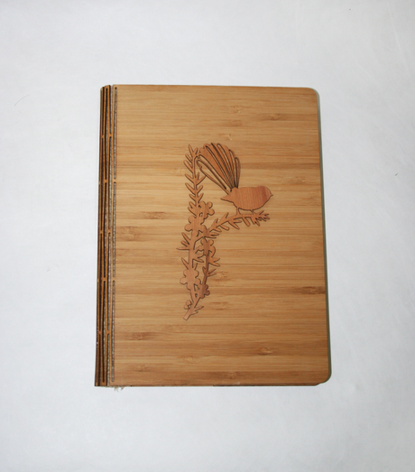 Elegant Notebook-Fantail in NZ Silver Beech and Bamboo Veneer, featuring a beautiful fantail design on manuka pattern.