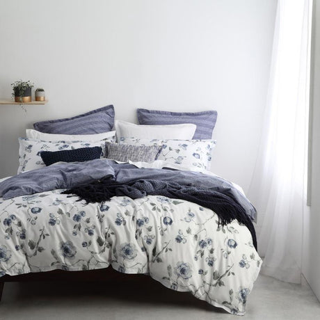 Double duvet cover set featuring floral print in slate blue and forest green on white, with stylish geometric reverse.