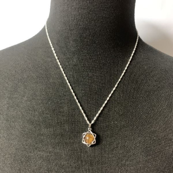 Tigers Eye Star Grounding Pendant featuring a star-shaped tigers eye gemstone known for its grounding and protective properties.