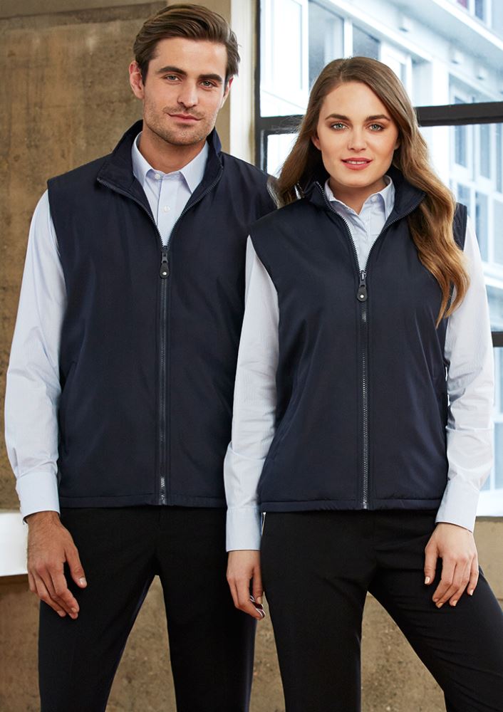 Versatile unisex reversible vest in navy, featuring micro fleece lining, full zipper, and adjustable drawstring hem for comfort.
