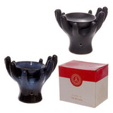 Elegant ceramic oil burners with open hands design; perfect for diffusing essential oils and creating a soothing ambiance.