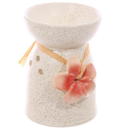 Ceramic oil and wax burners in speckled cream with floral designs, perfect for melting wax tarts and enhancing home decor.