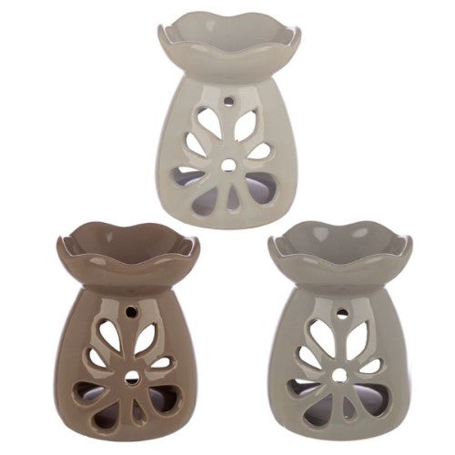 Elegant ceramic oil and wax burners in pastel floral designs, perfect for creating ambiance and enjoying delightful aromas.