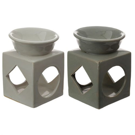 Set of 3 ceramic oil and wax burners with geometric cut-outs, perfect for enhancing ambiance with essential oils.