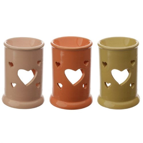 Elegant ceramic oil and wax burners in assorted designs, featuring heart cut outs for a cozy ambiance.